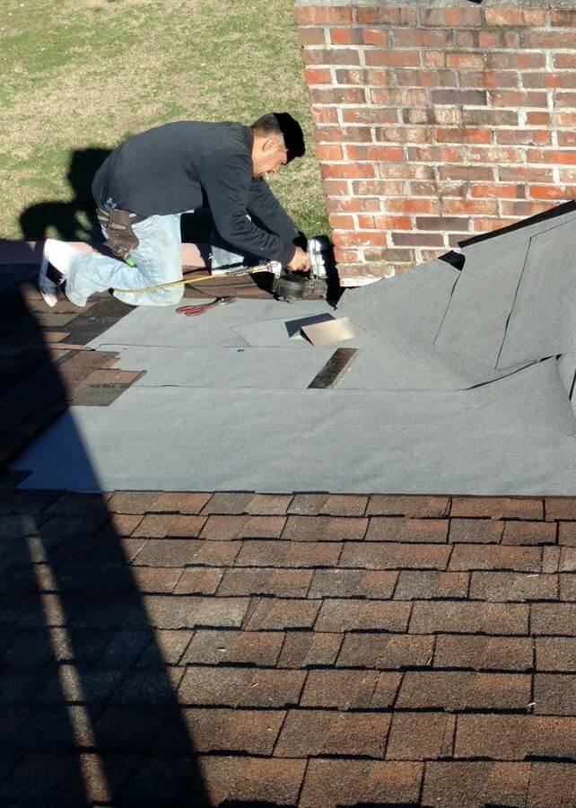 Worker Applying Roofing Material